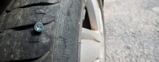Car tire with a nail sticking in it